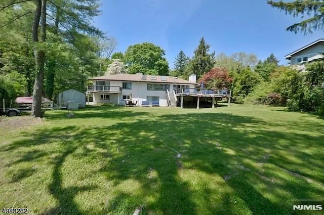 back of house with a yard and a deck