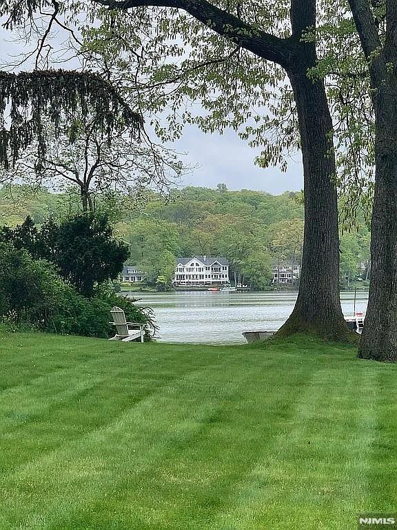 view of home's community featuring a yard and a water view