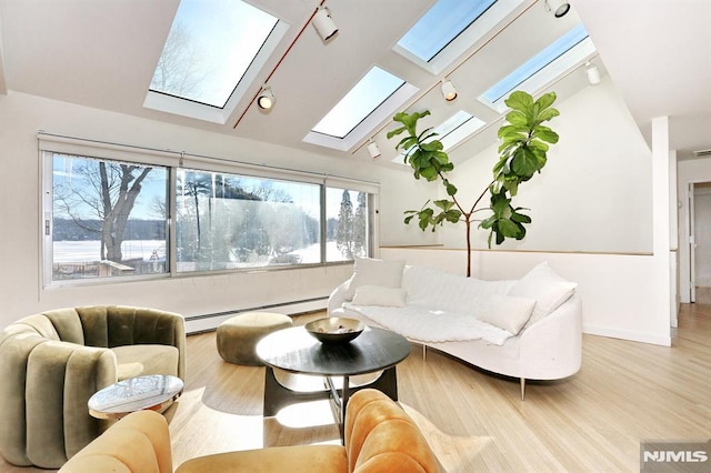 living room featuring a baseboard radiator, wood-type flooring, and vaulted ceiling with skylight