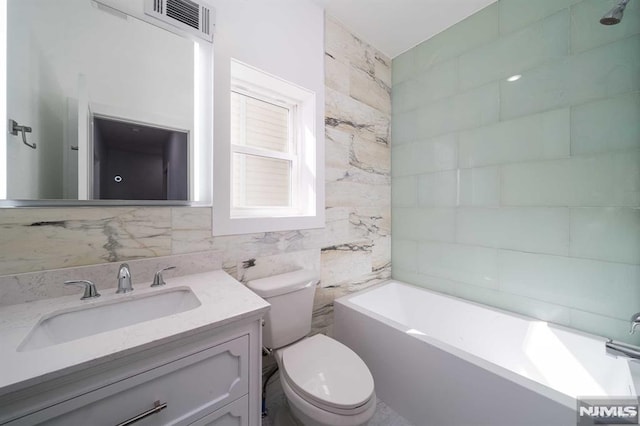 full bathroom with vanity, toilet, tub / shower combination, and tile walls