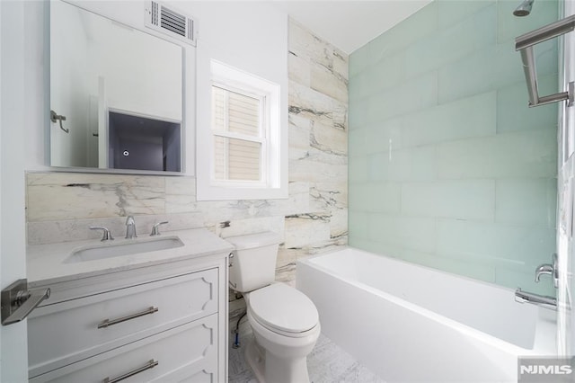 full bathroom with tile walls, backsplash, vanity,  shower combination, and toilet