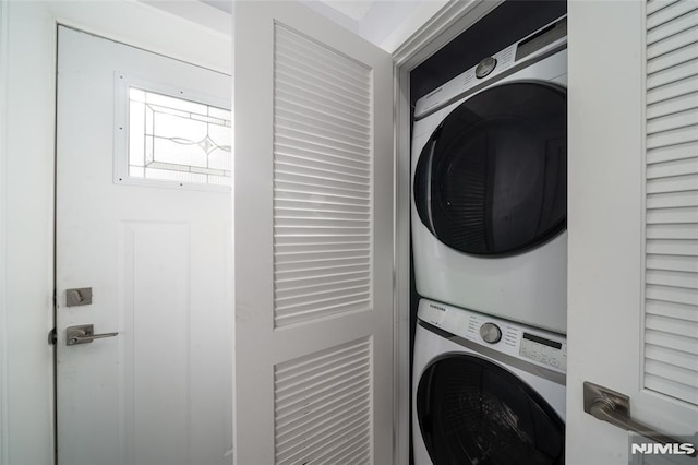 laundry room with stacked washer and clothes dryer