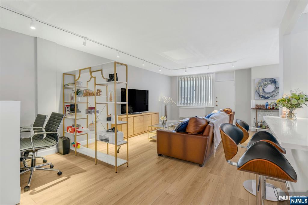 living room with track lighting and light wood-type flooring