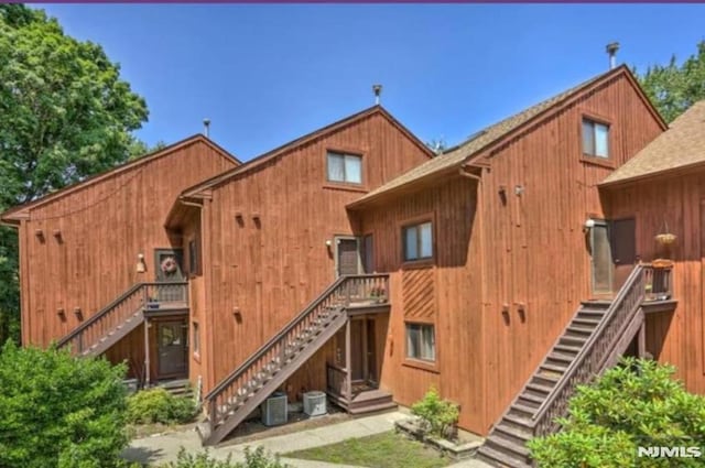 rear view of property featuring cooling unit