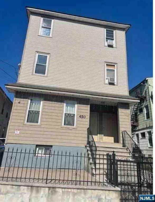 back of house with a fenced front yard