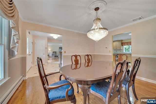 dining area featuring light wood-type flooring, visible vents, ornamental molding, baseboards, and baseboard heating