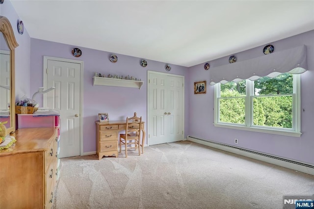 unfurnished bedroom with a baseboard radiator and carpet