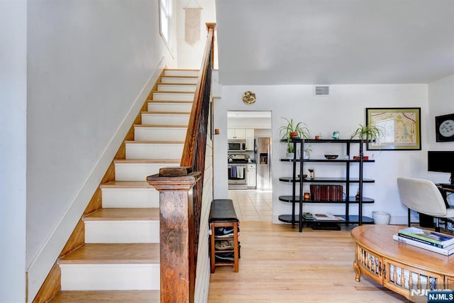 stairs with hardwood / wood-style floors