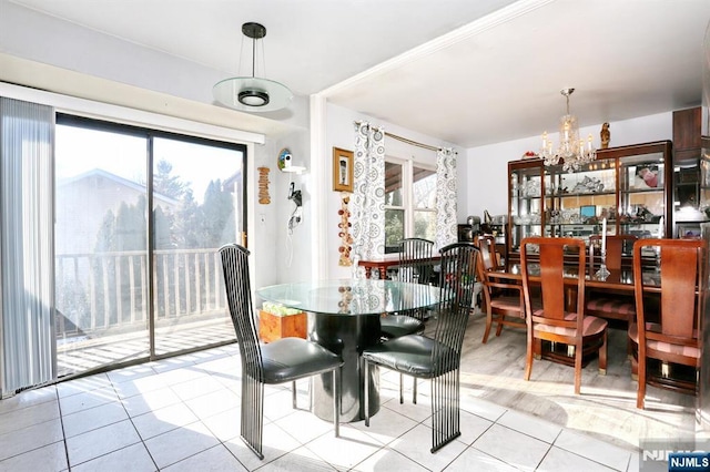 dining area featuring an inviting chandelier and light tile patterned floors