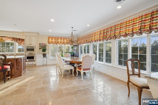 dining room with sink and ornamental molding