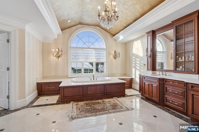 bathroom with an inviting chandelier, a bathing tub, and a healthy amount of sunlight