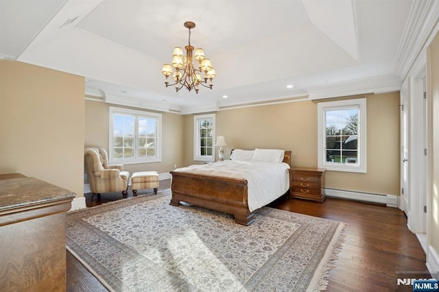 bedroom featuring multiple windows, a baseboard heating unit, and a tray ceiling