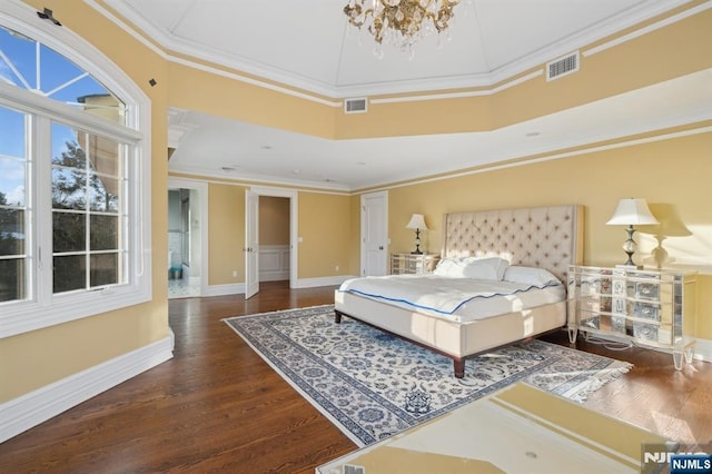 bedroom featuring dark hardwood / wood-style flooring, a notable chandelier, and ornamental molding