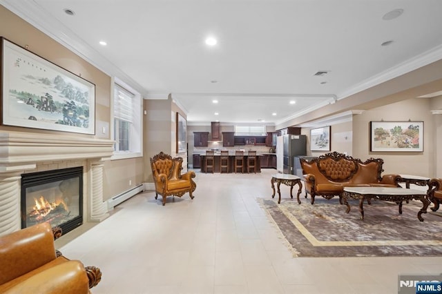 sitting room with ornamental molding and a baseboard heating unit