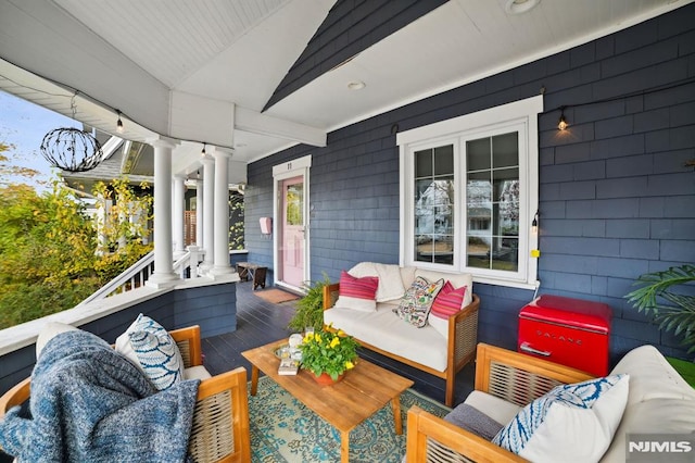 wooden terrace with an outdoor living space