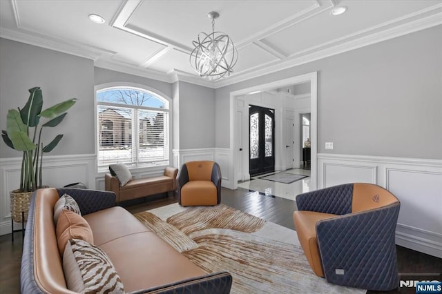 living room with an inviting chandelier, crown molding, and a healthy amount of sunlight