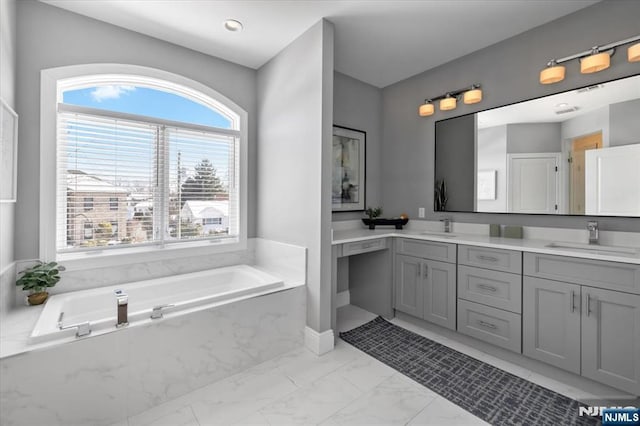 bathroom with vanity and a bathing tub