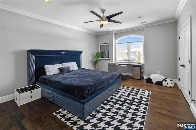 bedroom featuring dark hardwood / wood-style flooring, ornamental molding, and ceiling fan