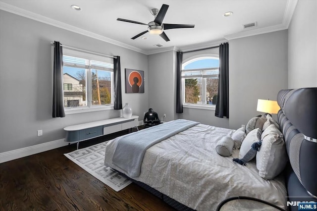 bedroom with dark wood-type flooring, ceiling fan, and ornamental molding