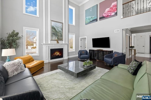 living room featuring ornamental molding, plenty of natural light, and dark hardwood / wood-style floors