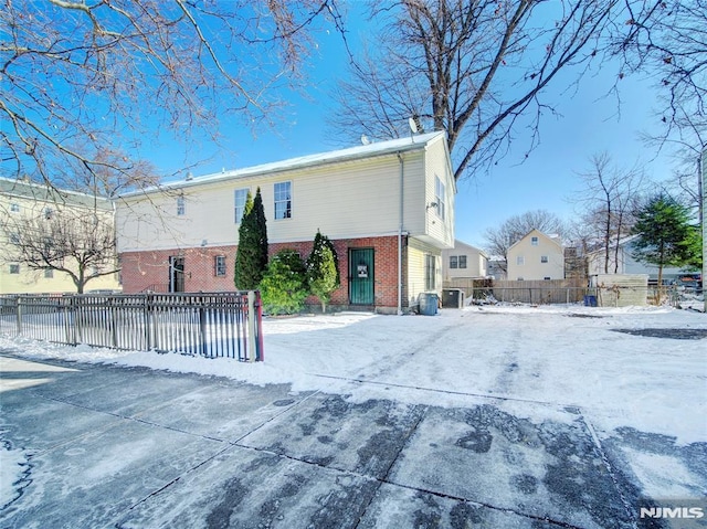 view of snow covered rear of property