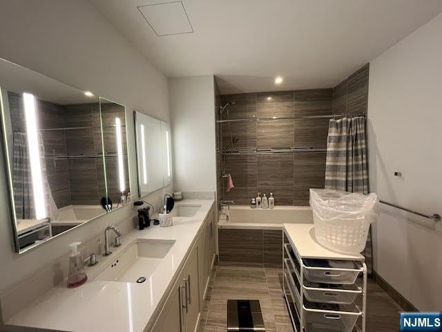 bathroom with shower / tub combo with curtain and vanity