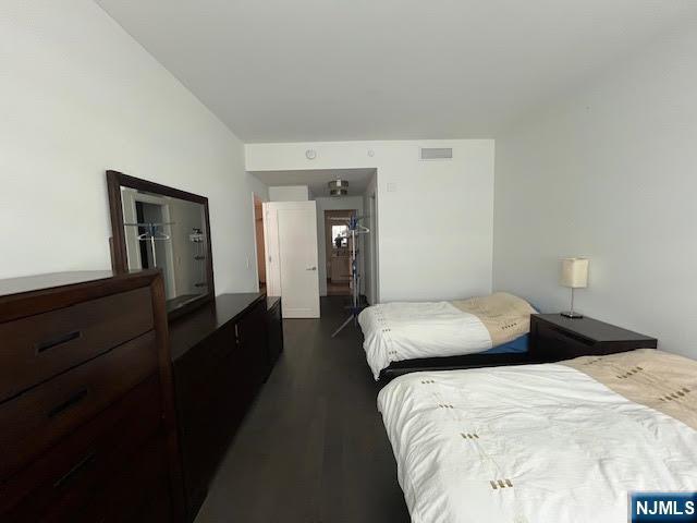 bedroom featuring dark wood-type flooring