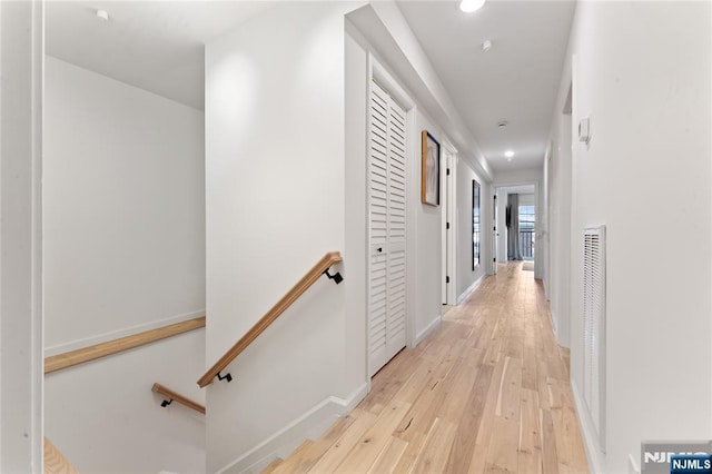 hallway with light hardwood / wood-style floors