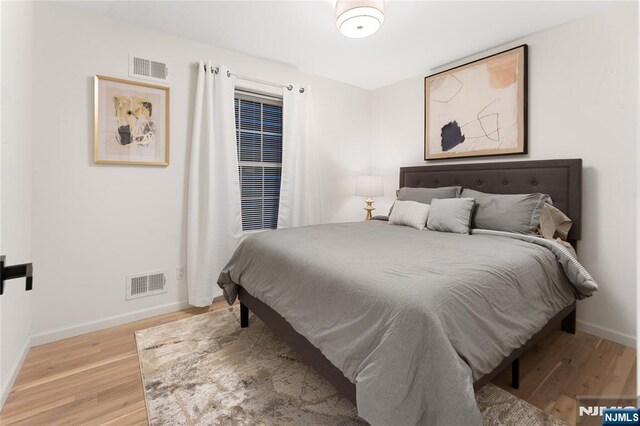 bedroom with light hardwood / wood-style floors