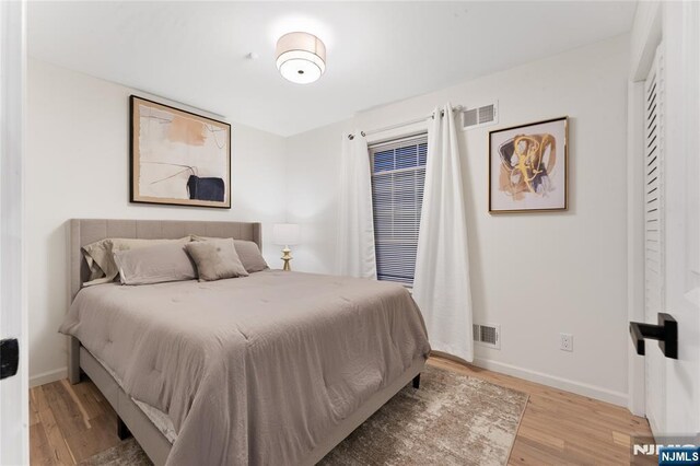 bedroom with hardwood / wood-style flooring