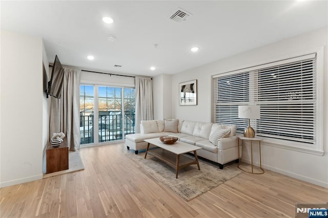 living room with light hardwood / wood-style flooring