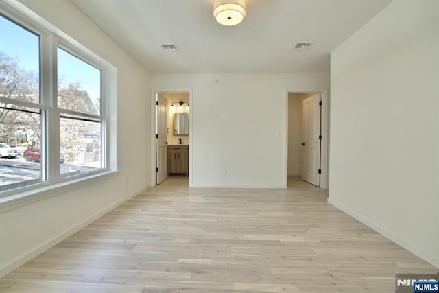 unfurnished room featuring light hardwood / wood-style floors