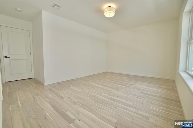 empty room with light hardwood / wood-style flooring