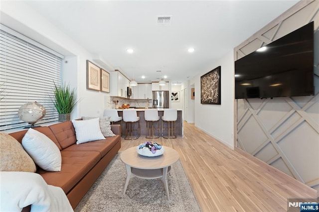 living room with light hardwood / wood-style flooring