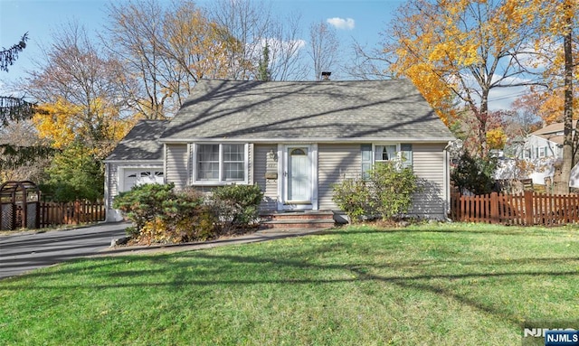 view of front of home featuring a garage and a front lawn