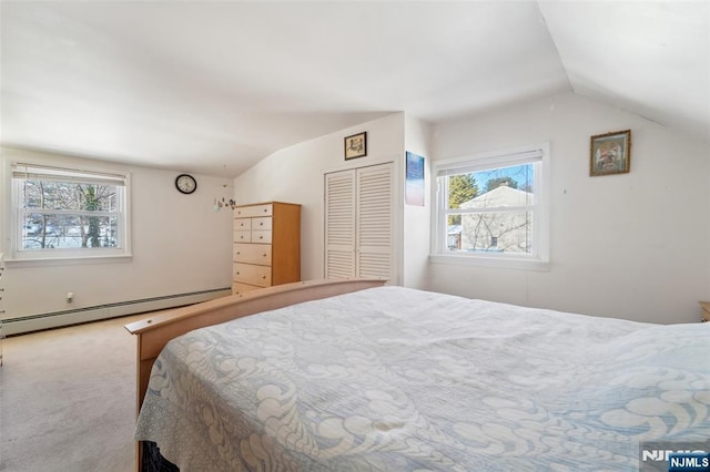 carpeted bedroom with lofted ceiling, multiple windows, and a baseboard radiator