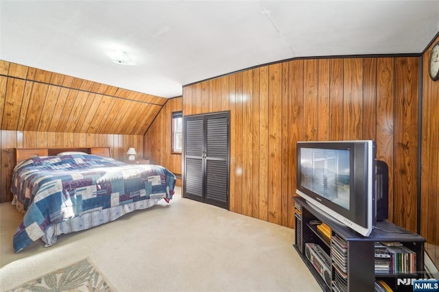 carpeted bedroom with wooden walls and vaulted ceiling