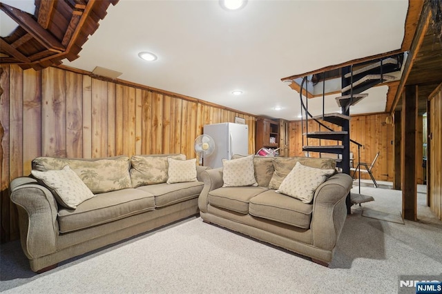 living room featuring light carpet and wood walls