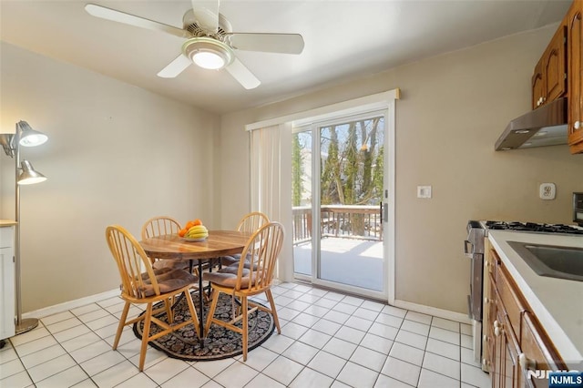 tiled dining area featuring ceiling fan