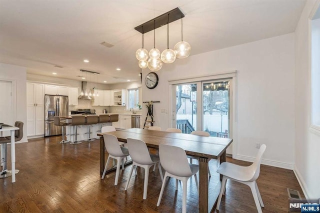 dining space featuring dark hardwood / wood-style floors and sink