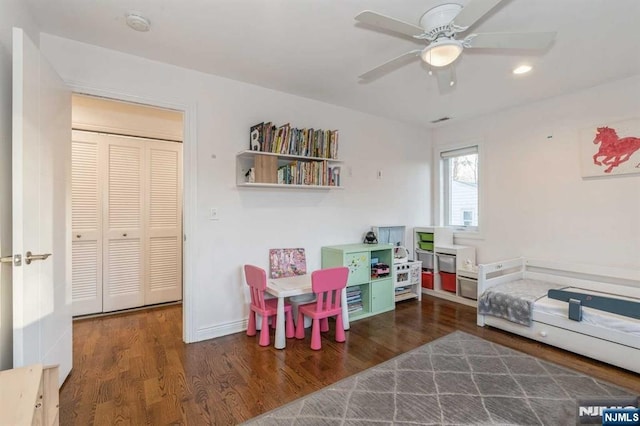 playroom featuring dark hardwood / wood-style floors and ceiling fan