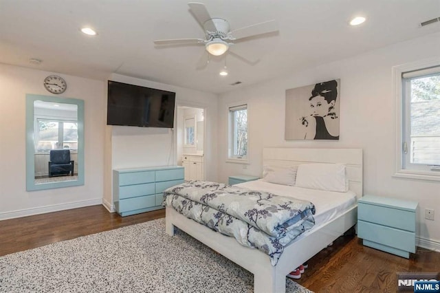 bedroom with dark hardwood / wood-style flooring, ensuite bath, and ceiling fan