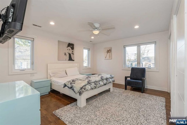 bedroom with dark hardwood / wood-style floors and ceiling fan