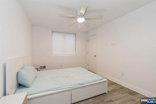 bedroom with hardwood / wood-style floors and ceiling fan