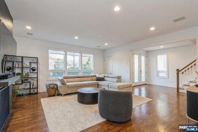 living room with dark hardwood / wood-style flooring