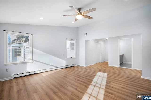 unfurnished living room featuring wood-type flooring, lofted ceiling, a baseboard heating unit, and ceiling fan