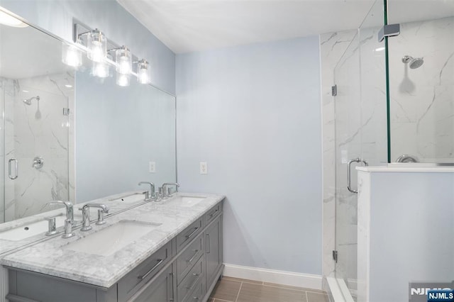 bathroom with vanity and a shower with door