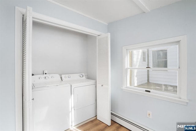 laundry room featuring separate washer and dryer, light wood-type flooring, and a baseboard heating unit