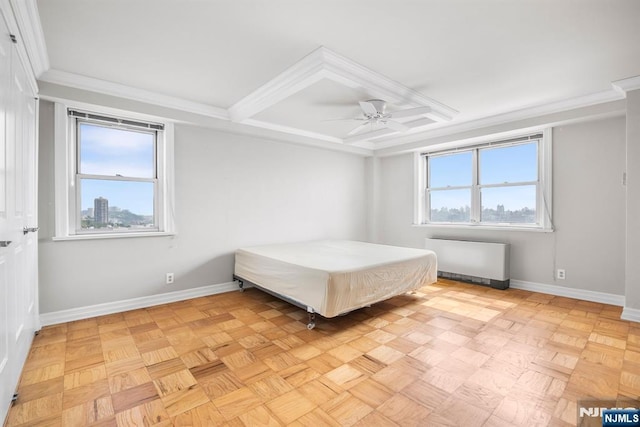 unfurnished bedroom featuring light parquet floors, radiator heating unit, ornamental molding, and ceiling fan