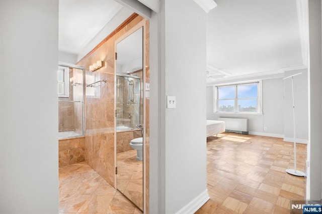 bathroom with bath / shower combo with glass door, toilet, and radiator